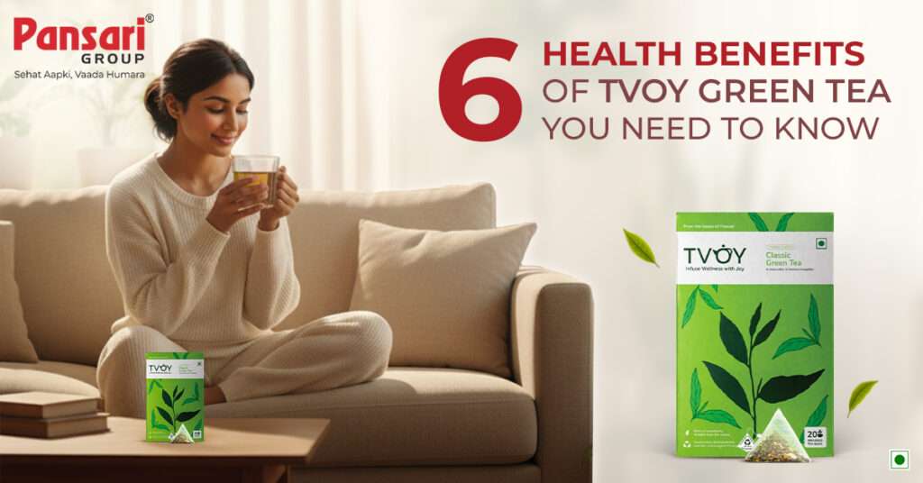Smiling woman on a couch holding a cup of tea with a box of TVOY Green Tea nearby, promoting its 6 health benefits.